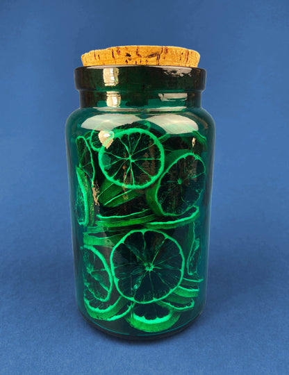 Green Glass Storage Jar with Dried  Orange Slices. Large, Deep Green Glass Canister with Cork Lid. Countertop Container.